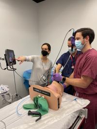 Three clinicians conduct a simulation